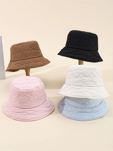 Detail showing heart-shaped quilted patterns on five colorful winter bucket hats