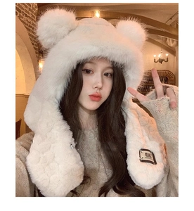 Detail showing plush white bear ear hat with integrated scarf and soft faux fur texture