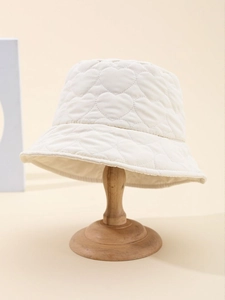 Detailed view of heart-shaped quilted pattern and soft texture on cream bucket hat
