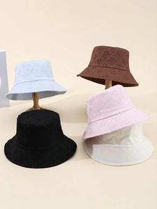Detail showing five colors of hollow floral embroidery bucket hats on wooden stands