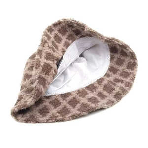 Detailed view of plush checkered bucket hat with soft faux fur texture and white lining