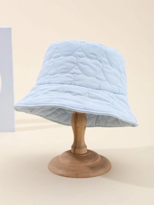 Close-up of heart pattern quilting on light blue bucket hat with warm padded texture