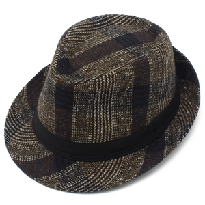 Detail of vintage tweed fedora hat featuring retro plaid pattern and black satin ribbon