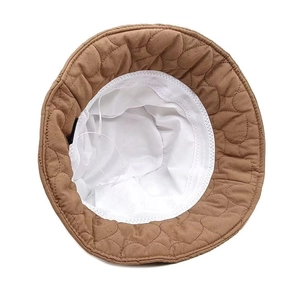 Detail view of heart-quilted bucket hat showing white breathable mesh lining and sweatband