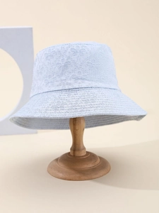 Detailed macro shot of light blue bucket hat featuring premium 3D floral embroidery textures