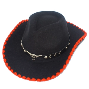 Detail of western cowboy felt hat featuring red stitched brim and silver bull head badge