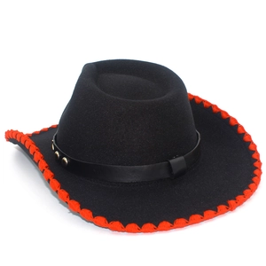 Detail of black felt cowboy hat with red stitched edge and studded leather band
