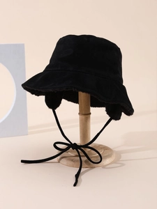 Detailed view of black suede bucket hat with warm fleece lining and adjustable chin straps