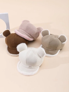 Close-up detail of plush bear ears and soft knitted texture on colorful winter hats