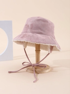 Detail of pink faux suede bucket hat with soft white fleece lining and adjustable chin strap