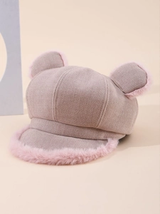Detailed view of knitted fabric texture with pink plush trim on a cute cat ear hat