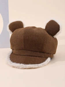 Detail of a brown winter hat with plush cat ears and soft beige fleece lining trim