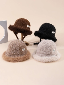 Close-up of winter plush bucket hats in four colors with faux fur trim and woven labels