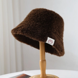 Winter plush bucket hat in dark brown faux fur with a cute bear patch detail
