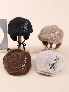 Detailed plush winter ear-flap hat with elegant embroidery and soft fleece texture