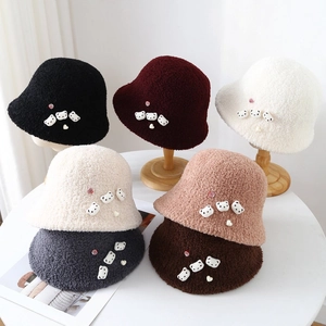 Detail of soft fleece bucket hats in multiple colors featuring cute 3D bear ornaments