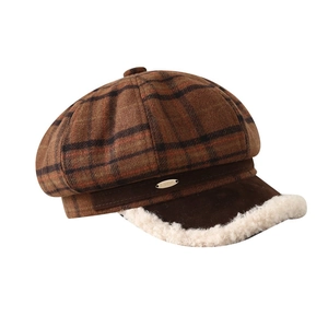 Close-up of vintage plaid newsboy hat with brown suede brim and white sherpa lining