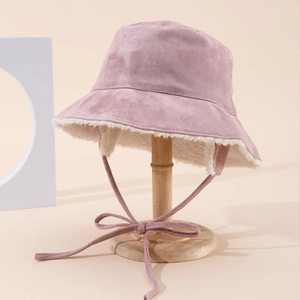 Pink suede fisherman hat with plush lining and ear protection ties for winter warmth