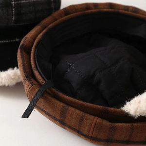 Close-up of vintage plaid beret with warm quilted lining and plush faux fur trim