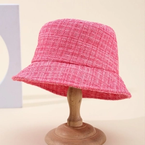 Classic rose pink tweed bucket hat for women on a wooden stand with a textured weave