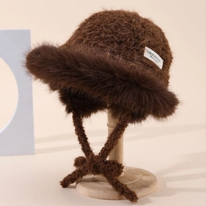 Brown plush winter bucket hat with faux fur trim and lace-up ear protection