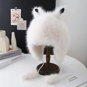 White faux fur winter hat with cute cat ears and long earflaps with soft pompom ties