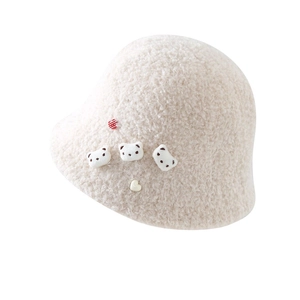 Detail shot of plush sherpa bucket hat featuring three cute 3D teddy bear ornaments