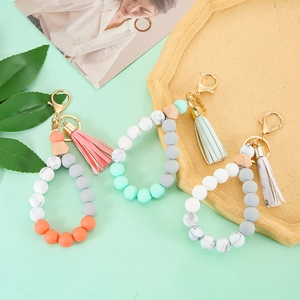 Silicone and wooden bead keychain bracelet with marble patterns and fringe tassel