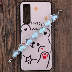 Close-up of a cartoon bear phone case featuring a transparent blue heart beaded chain