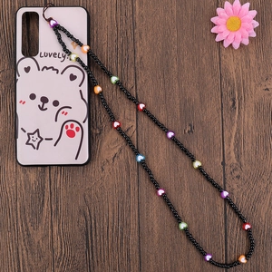 Detail of beaded phone lanyard with colorful heart beads and a cartoon bear case