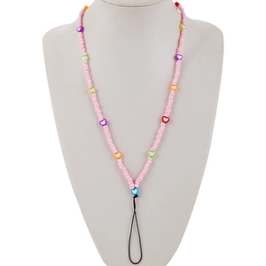 Detail of pink beaded phone lanyard with colorful acrylic heart charms and black loop connector