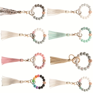 Detail of colorful silicone beaded bracelets with leopard print wood beads and leather tassels