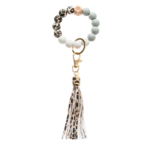 Detail of silicone beaded keychain bracelet with leopard print tassel and gold ring