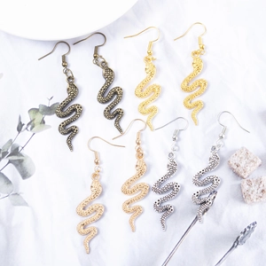 Creative snake earrings in bronze, gold, and silver finishes with realistic scale texture