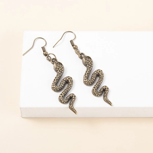Detailed macro view of vintage bronze snake-shaped earrings showing fine scale textures