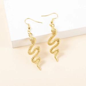 Detailed macro view of golden snake-shaped alloy earrings with textured scales