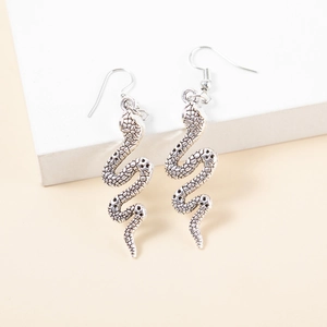 Detailed close-up of snake earrings showing intricate silver scale textures and fishhooks