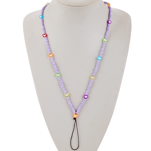 Detail of handmade colorful heart beaded phone lanyard on a grey mannequin bust display