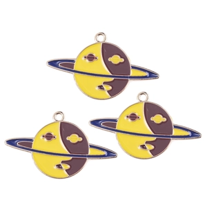 Three enamel Saturn planet charms with yellow and brown yin-yang design for DIY jewelry