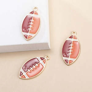 Macro shot of American football charms with enamel inlay and gold-tone metal loop
