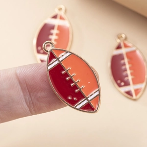 Macro detail of enamel rugby charm with gold metal loop for DIY jewelry making