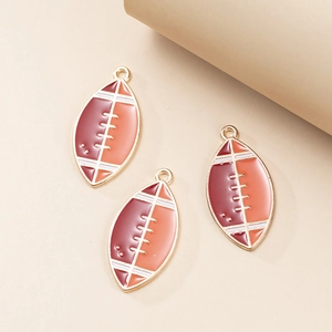 Detailed macro of American football alloy charms with red enamel and white stitching