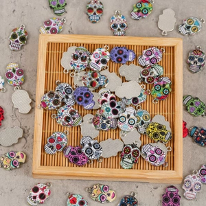 Detailed macro view of colorful enamel skull charms for DIY jewelry on bamboo tray