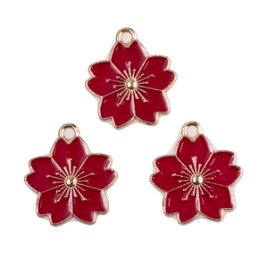 Detail view of cherry blossom alloy charms with red enamel and gold metallic edges