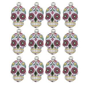 Detail of 12 colorful Day of the Dead skull charms with intricate floral eye patterns