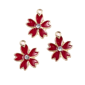 Close-up of red enamel cherry blossom charms with rhinestones for DIY jewelry making