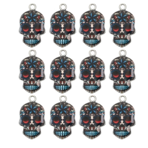 Close-up of 12 colorful Day of the Dead sugar skull alloy charms for DIY jewelry making