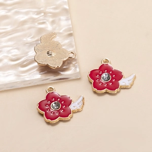Detail of red flower alloy pendant with white wings and sparkling rhinestone center
