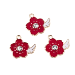Detailed view of red alloy flower charms with white rhinestone and gold-tone plating