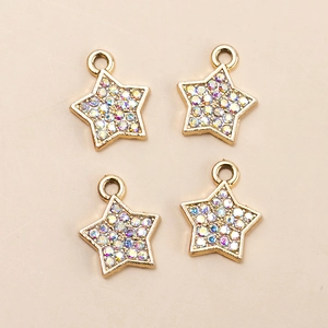 Close-up of four gold star alloy pendants with rainbow AB rhinestones for DIY jewelry